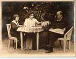 Emile Zola with his wife and two children Jacques and Denise sitting in the garden