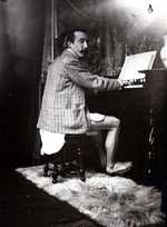 Gauguin, c. 1895, playing a harmonium at Alphonse Mucha's studio at rue de la Grande-Chaumière, Paris 